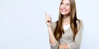 beautiful-young-woman-pointing-up-over-white-background_1301-7744